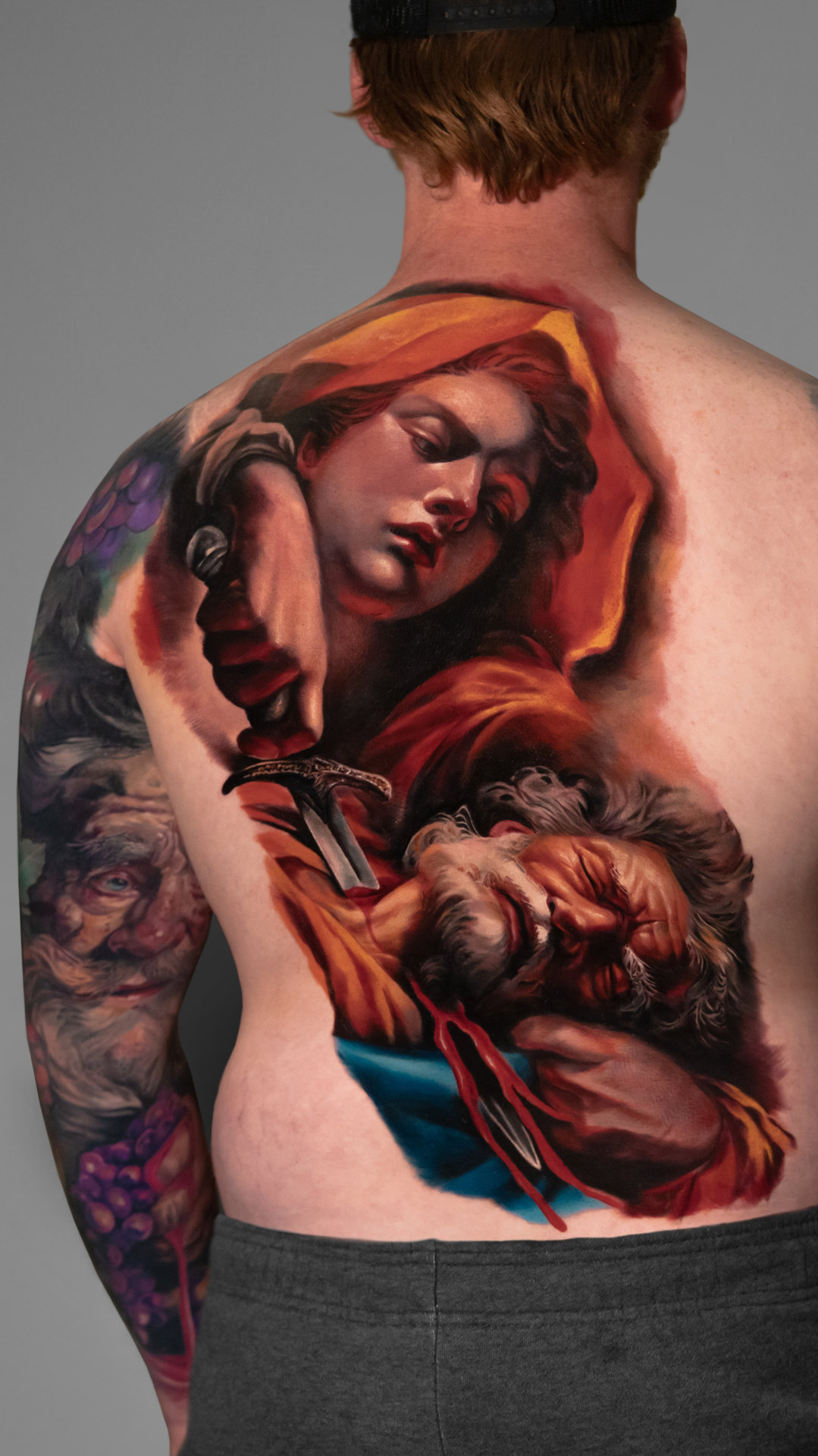 Fine-art inspired color realism back tattoo by Tony Vilella